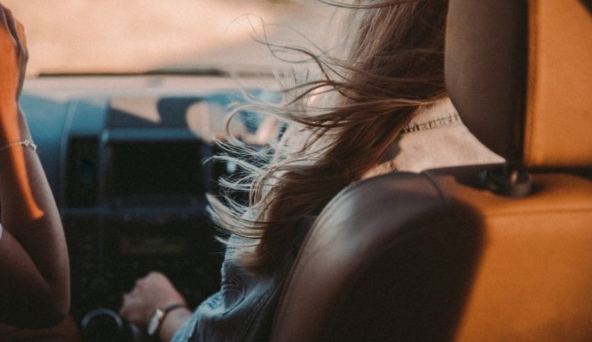 Two women sitting in the back seat of a car.