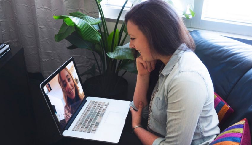 A woman looking at a laptop screen.