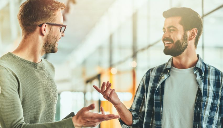 Two men talking to each other in an office.