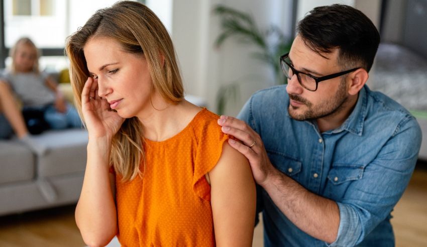 A man is helping a woman with a headache at home.