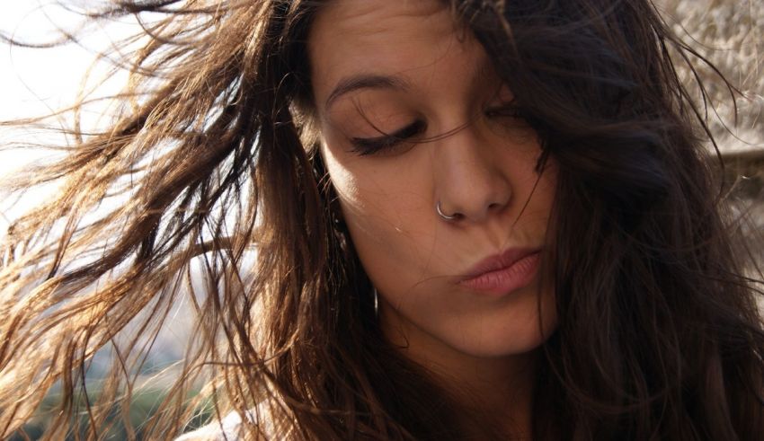 A woman with her hair blowing in the wind.