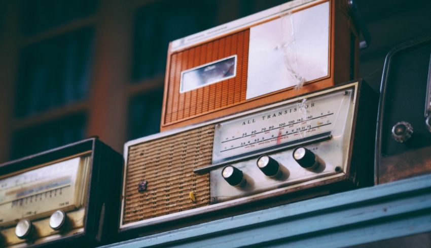 Old radios stacked on top of each other.