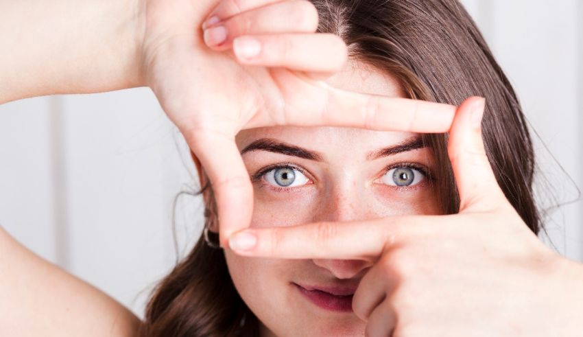 A woman is making a frame with her hands.