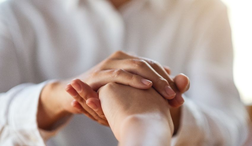 A person is holding another person's hand.