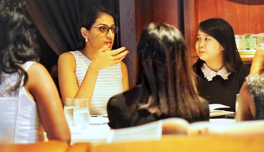 A group of women sitting around a table in a restaurant.