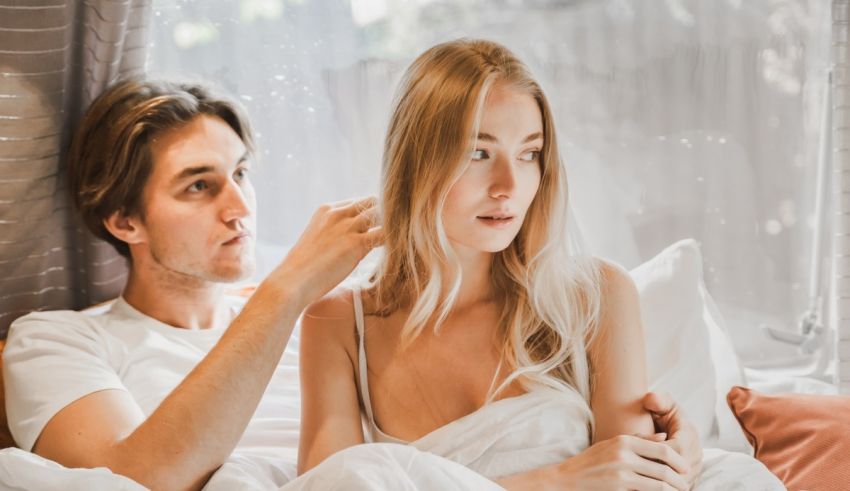 A man and woman laying in bed together.