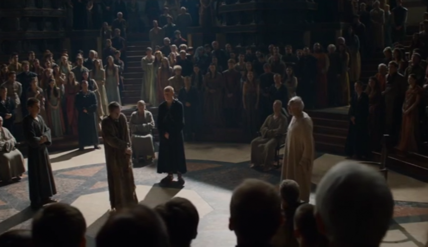 A group of people standing in a large room.