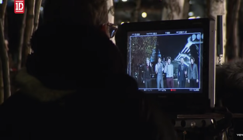 A man is filming a scene in front of a camera.