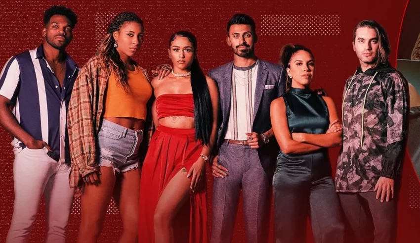 A group of people posing in front of a red background.