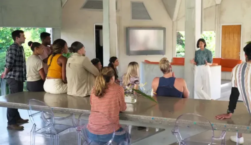 A group of people standing around a table.