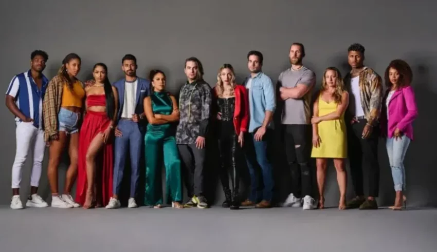 A group of people standing in front of a gray background.